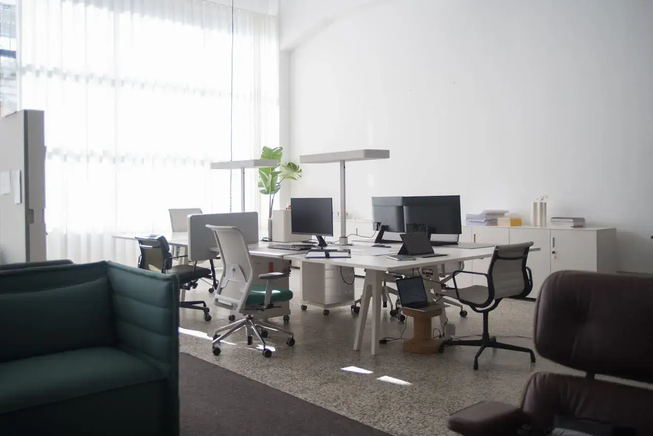 A bright and spacious modern office interior with multiple workstations.