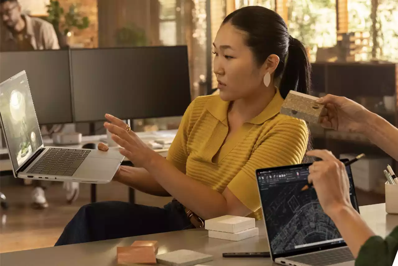 Two people collaborating on laptops