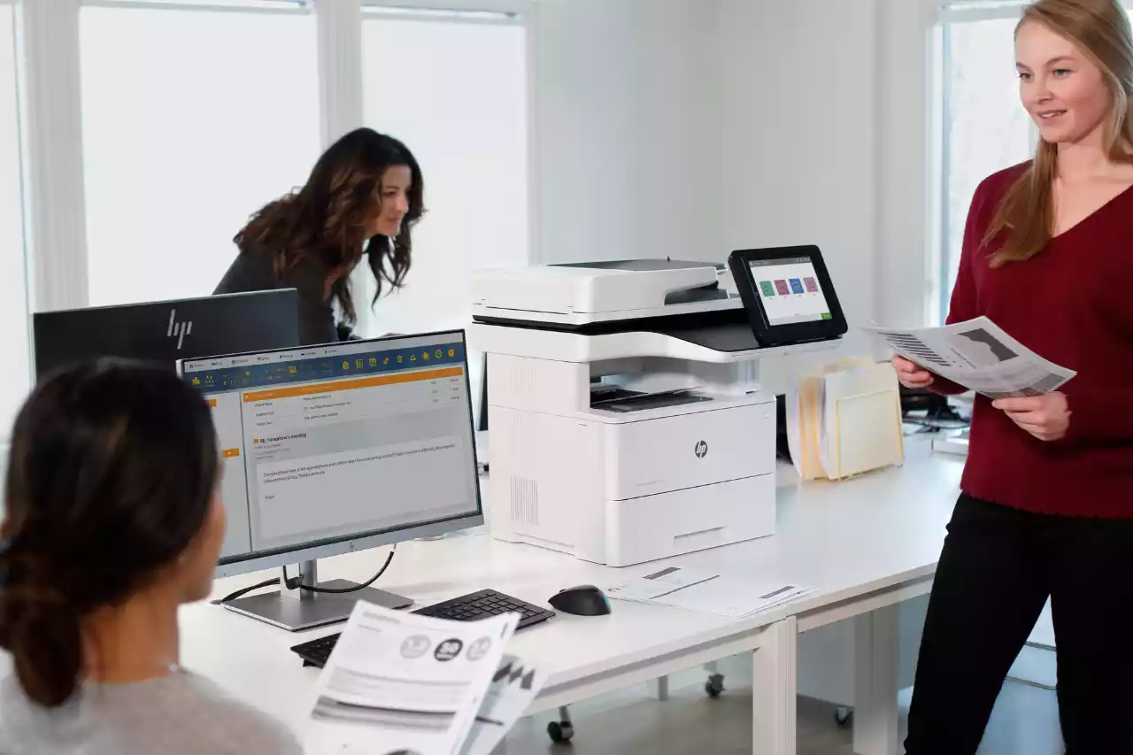 An office scene depicting chaos with scattered papers and a woman in focus.